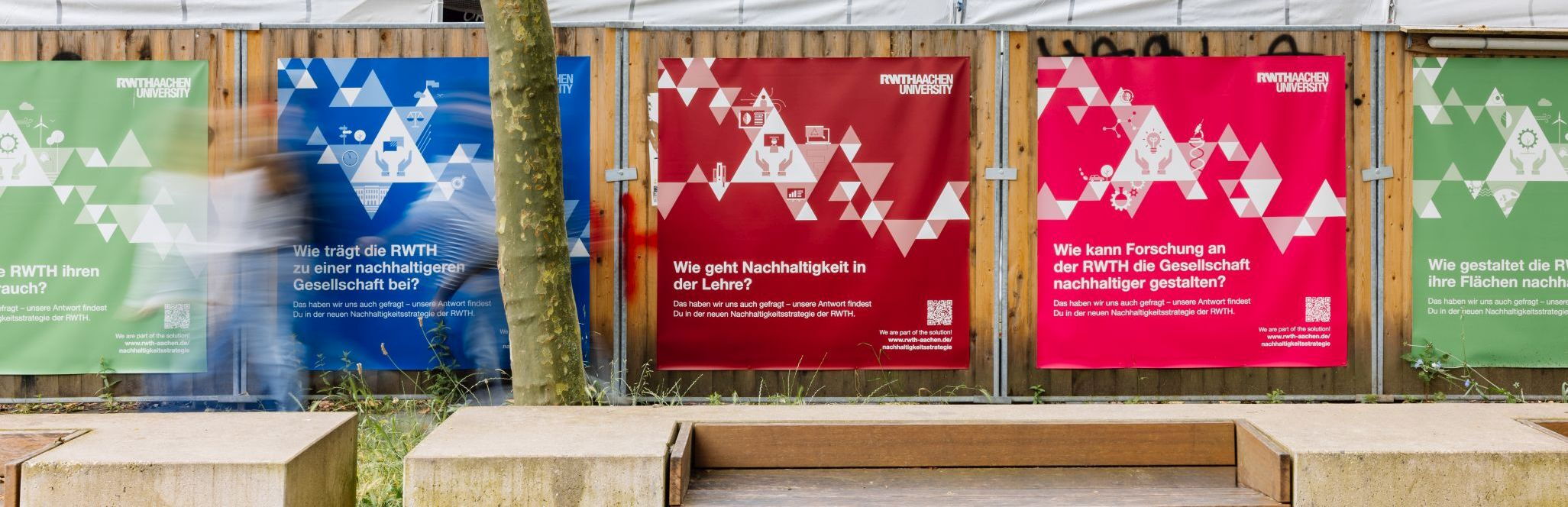 Banner zur Nachhaltigkeit an der RWTH Aachen auf einem Bauzaun.